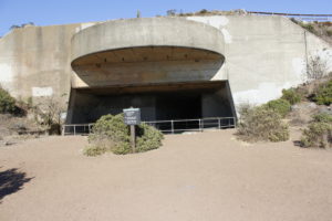 A concrete gun emplacement built into a hillside.